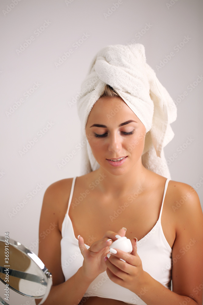 portrait of a beautiful woman applying face cream for skin care portrait of a beautiful woman applying face cream for skin care