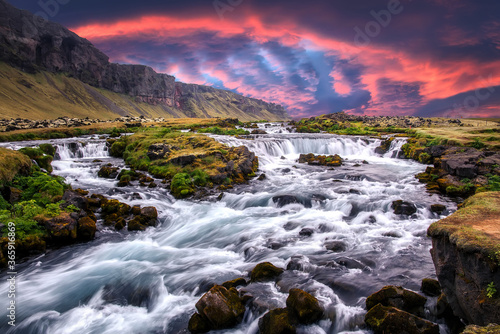 Scenic image of Iceland nature. Amazing Natural scenery. Colorful summer sunrise, Waterfall with dramatic picturesque sky. Picture of wild area. Iceland the most beautiful and best travel place © jenyateua