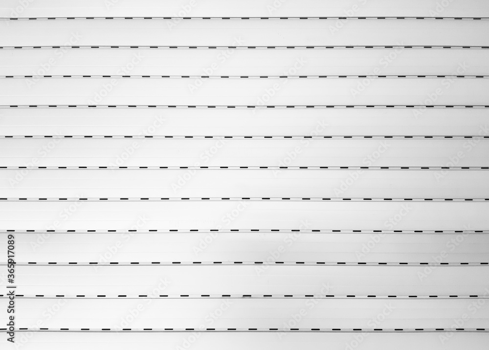 CLOSED WHITE ROLLER BLIND BACKGROUND. Patterns and texture. Abstract. Background of white grunge metallic roller shutter surface CLOSED WHITE ROLLER BLIND BACKGROUND. Patterns and texture. Abstract. Background of white grunge metallic roller shutter surface