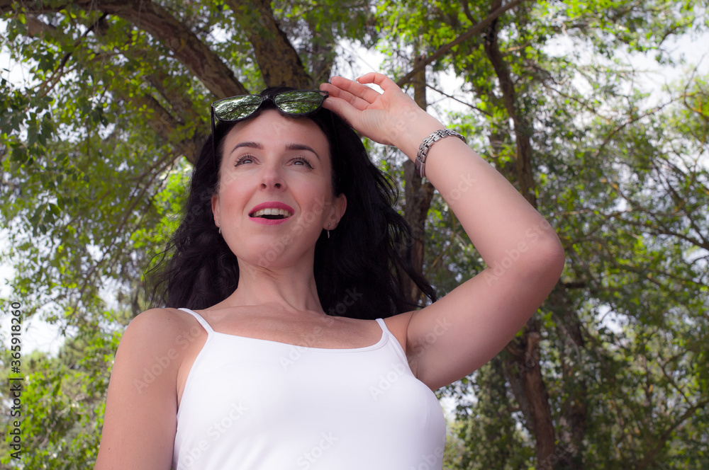 Surprised and smiling woman, with mirror glasses, in nature. Surprised and smiling woman, with mirror glasses, in nature.