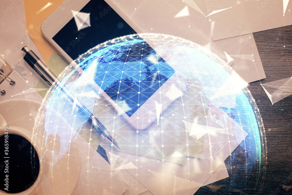Double exposure of business theme hologram over desktop with phone. Top view. Mobile international trade connection concept. Double exposure of business theme hologram over desktop with phone. Top view. Mobile international trade connection concept.