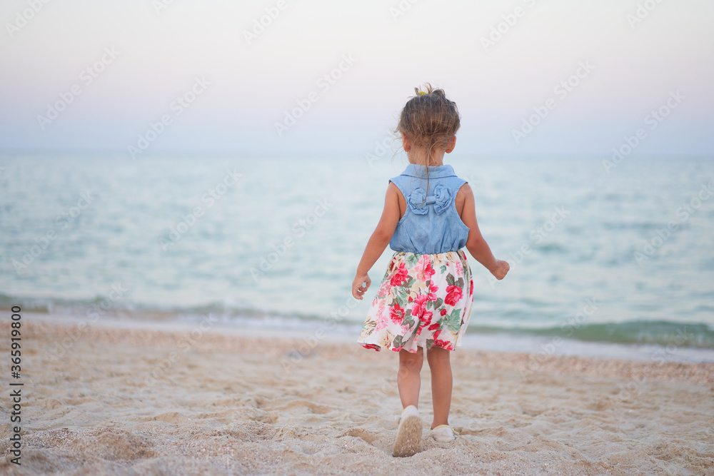 Child playing sand beach Little girl play sad alone summer family vacation Child playing sand beach Little girl play sad alone summer family vacation