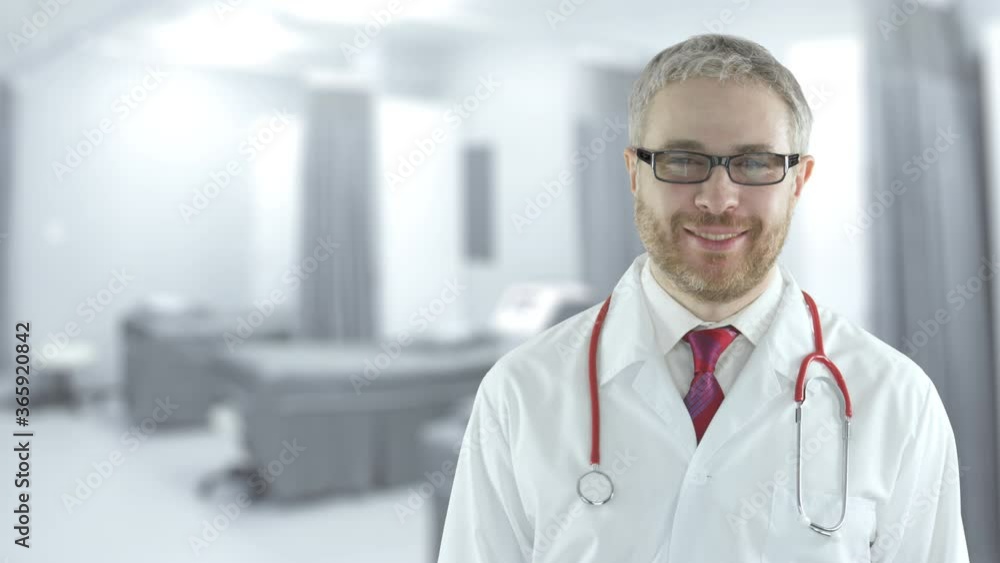 Portrait of a smiling male doctor in a modern hospital ward. Shot on Red camera Portrait of a smiling male doctor in a modern hospital ward. Shot on Red camera