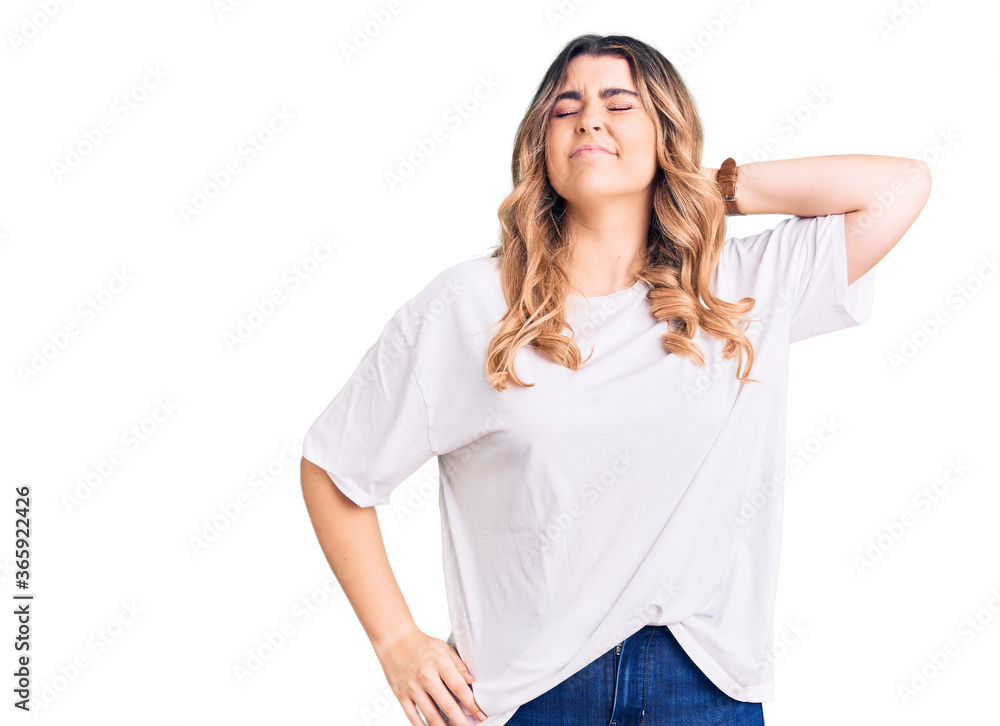 Young caucasian woman wearing casual clothes suffering of neck ache injury, touching neck with hand, muscular pain Young caucasian woman wearing casual clothes suffering of neck ache injury, touching neck with hand, muscular pain