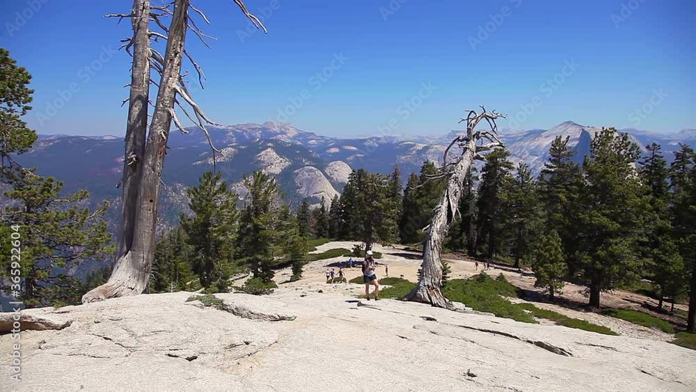 Hiking woman in Yosemite National Park at Sentinel Dome summit. Cheering happy hiker enjoying view of popular El Capitan from Sentinel Dome. Summer travel holidays in California, United States Hiking woman in Yosemite National Park at Sentinel Dome summit. Cheering happy hiker enjoying view of popular El Capitan from Sentinel Dome. Summer travel holidays in California, United States