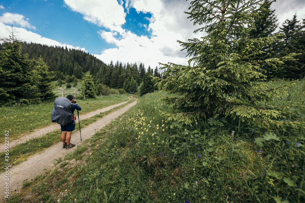 A man riding a bike down a dirt road A man riding a bike down a dirt road