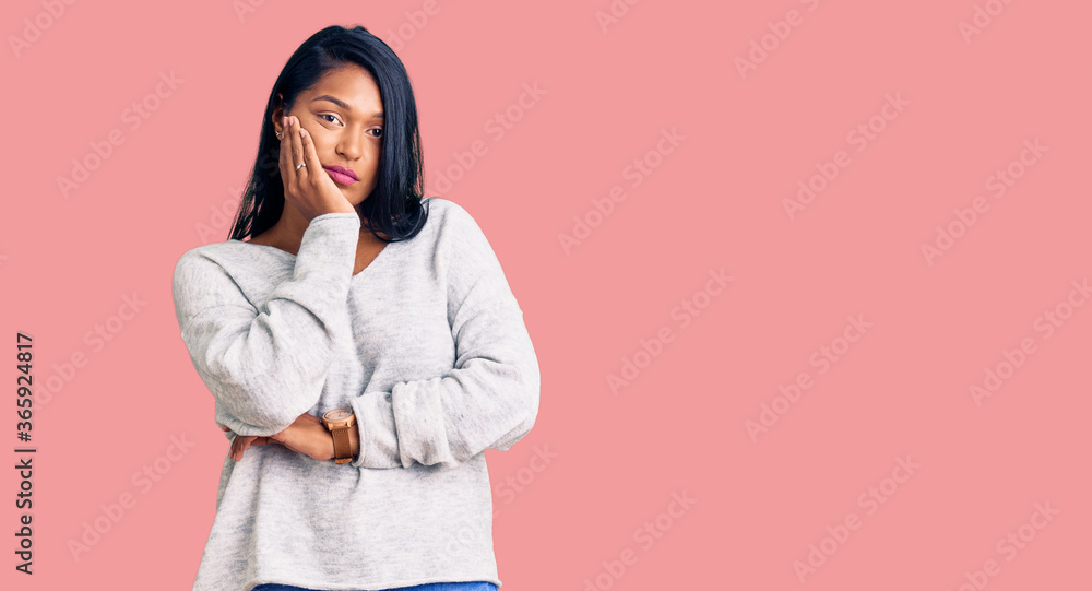Hispanic woman with long hair wearing casual clothes thinking looking tired and bored with depression problems with crossed arms. Hispanic woman with long hair wearing casual clothes thinking looking tired and bored with depression problems with crossed arms.