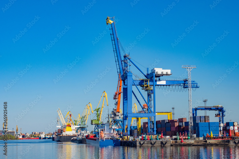 Cargo port. Freight port and loading cranes sky background. Sea loading terminal. Cargo ships in seaport. Ships moored for loading. Transportation by ship. Huge cranes for unloading sea containers