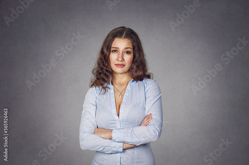 Skeptical unhappy woman standing with arms folded