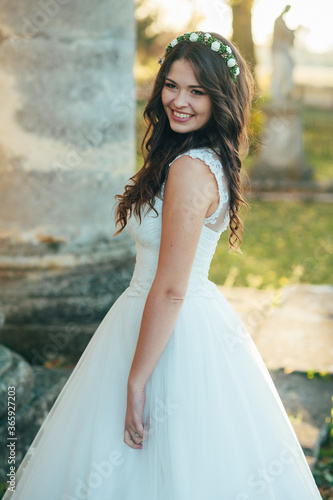 Beautiful happy bride outdoors at sunset. Beautiful woman. Beautiful bride in white dress. Sexy bride. Bride portrait wedding makeup and hairstyle, fashion.