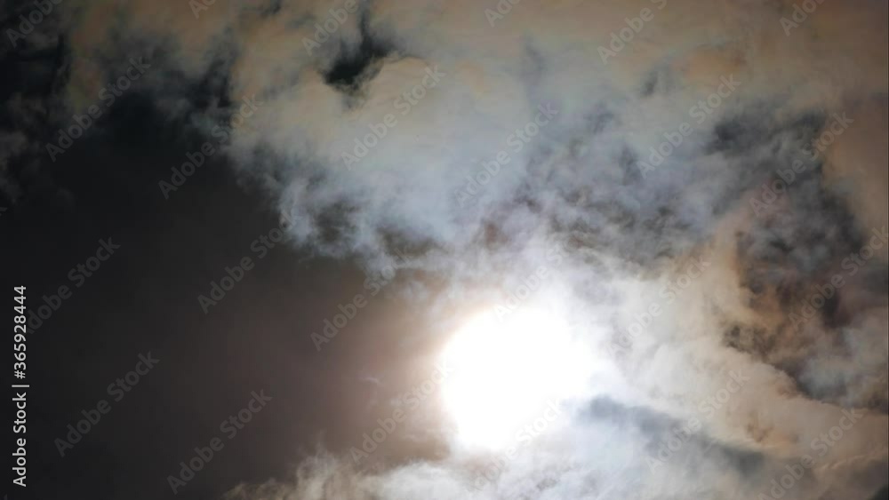 Dramatic timelapse of clouds passing in front of the sun creating lighting effects Dramatic timelapse of clouds passing in front of the sun creating lighting effects