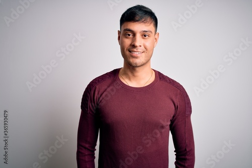 Photos Young handsome hispanic man wearing casual shirt standing over white isolated background with a happy and cool smile on face
