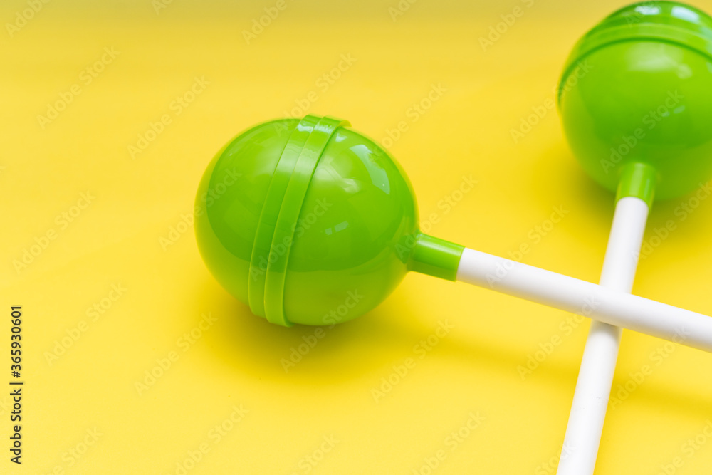Lollipops on bright yellow background