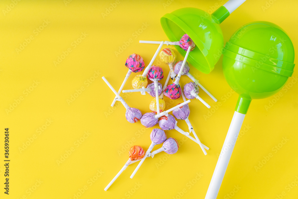 Lollipops on bright yellow background