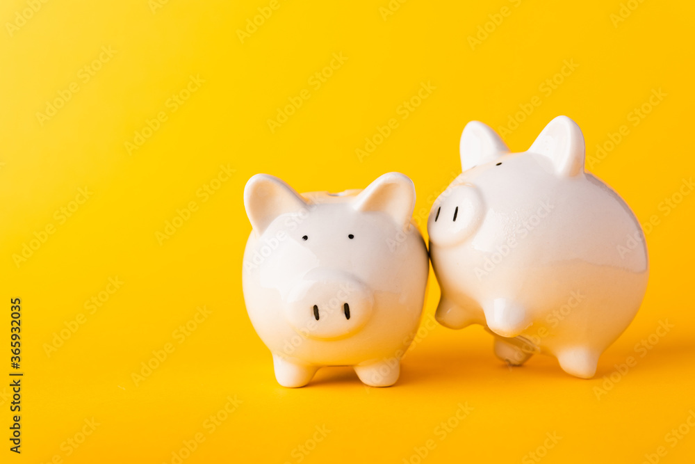 International Friendship Day, Front two small white fat piggy bank, studio shot isolated on yellow background and copy space for use, Finance, deposit saving money concept International Friendship Day, Front two small white fat piggy bank, studio shot isolated on yellow background and copy space for use, Finance, deposit saving money concept
