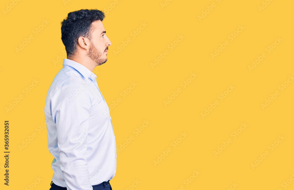 Young hispanic man wearing business clothes looking to side, relax profile pose with natural face with confident smile. Young hispanic man wearing business clothes looking to side, relax profile pose with natural face with confident smile.