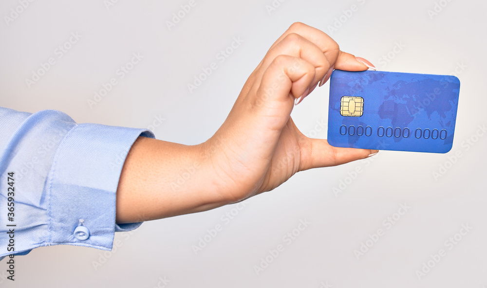 Hand of caucasian young woman holding credit card over isolated white background Hand of caucasian young woman holding credit card over isolated white background