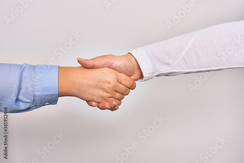 Handshake of two hands of young caucasian businesswomen for agreement over isolated white background