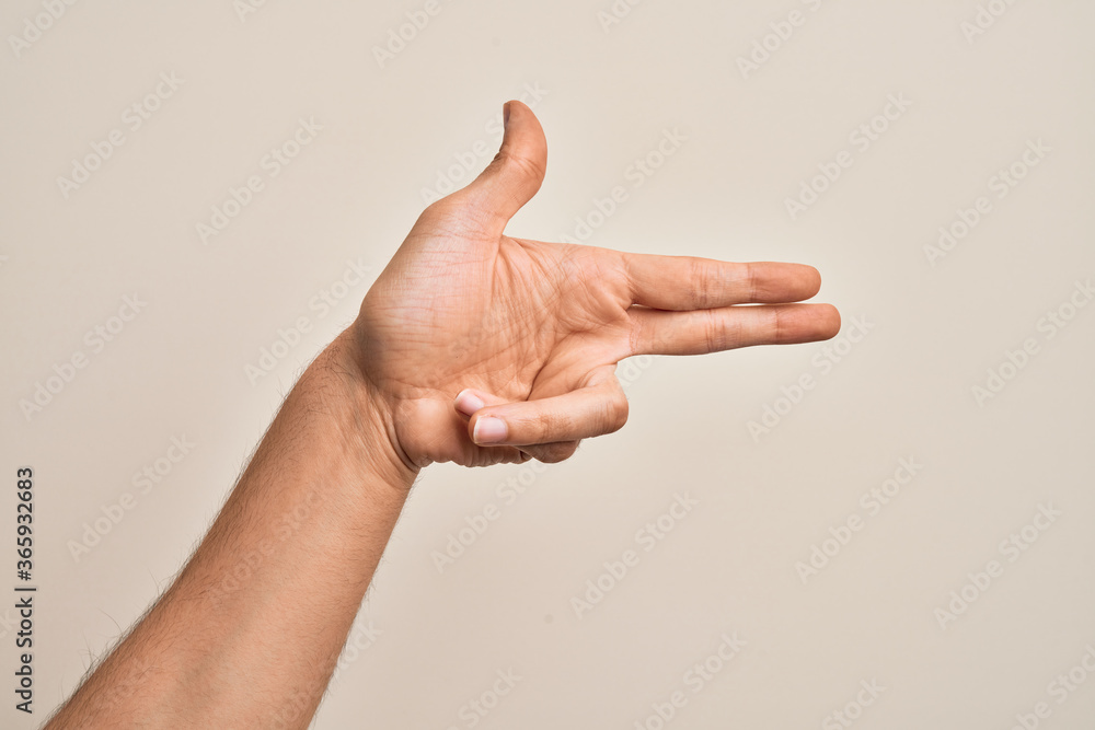 Hand of caucasian young man showing fingers over isolated white background gesturing fire gun weapon with fingers, aiming shoot symbol Hand of caucasian young man showing fingers over isolated white background gesturing fire gun weapon with fingers, aiming shoot symbol