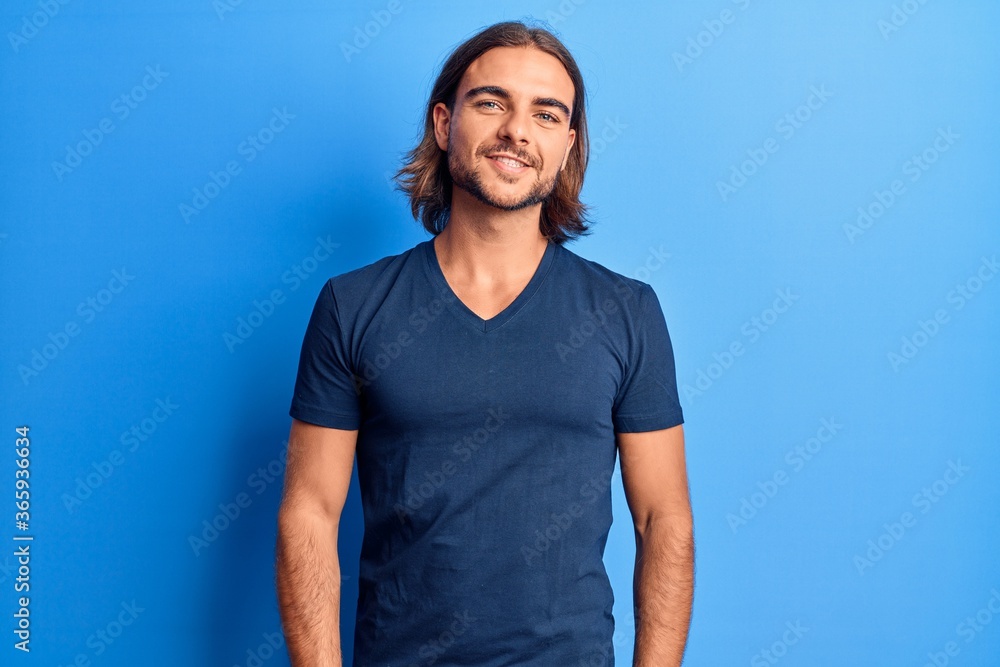 Young handsome man wearing casual clothes with a happy and cool smile on face. lucky person. Young handsome man wearing casual clothes with a happy and cool smile on face. lucky person.
