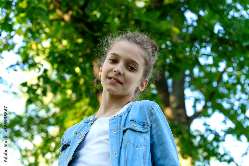 Girl in blue denim clothes posing in the park. Girl in blue denim clothes posing in the park.