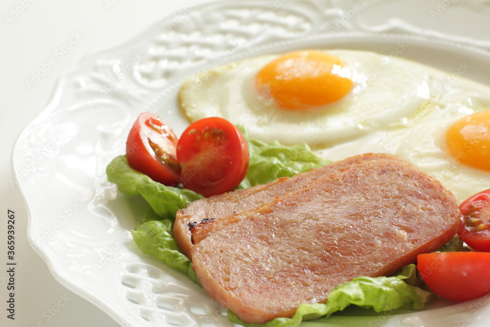 Luncheon meat and sunny side up fried egg for homemade breakfast