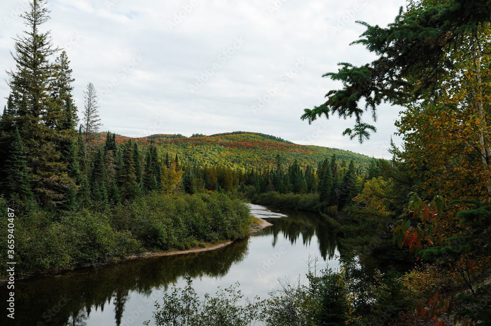 Scenery of Autumn landscape stock photos. Autumn scenery landscape showing colourful nature autumn scene with colourful trees, river, sky, clouds, in a tranquil peaceful feeling. Picture. Image. 