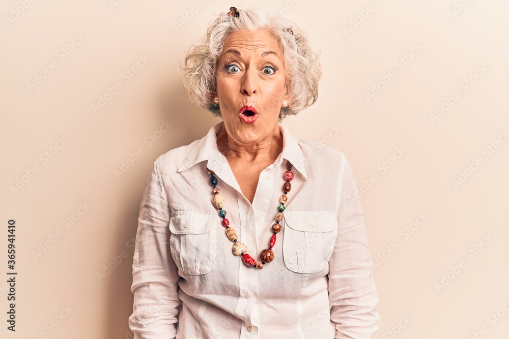 Senior grey-haired woman wearing casual clothes scared and amazed with open mouth for surprise, disbelief face