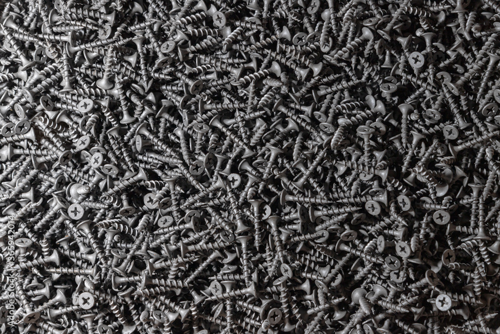 Wood screws. Texture. Background for wallpaper. A lot of black screws. View from above. Wood screws. Texture. Background for wallpaper. A lot of black screws. View from above.