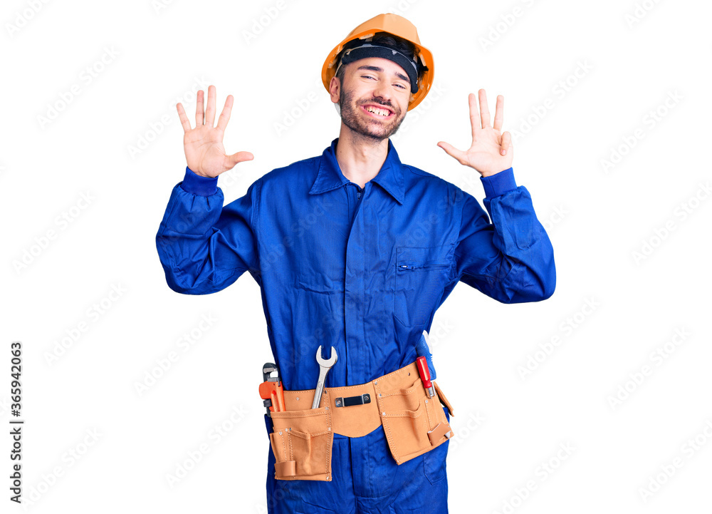Young hispanic man wearing worker uniform showing and pointing up with fingers number nine while smiling confident and happy. Young hispanic man wearing worker uniform showing and pointing up with fingers number nine while smiling confident and happy.