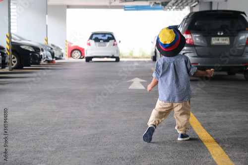 Little boy walking in car parking wear summer vacation cloth © themorningglory