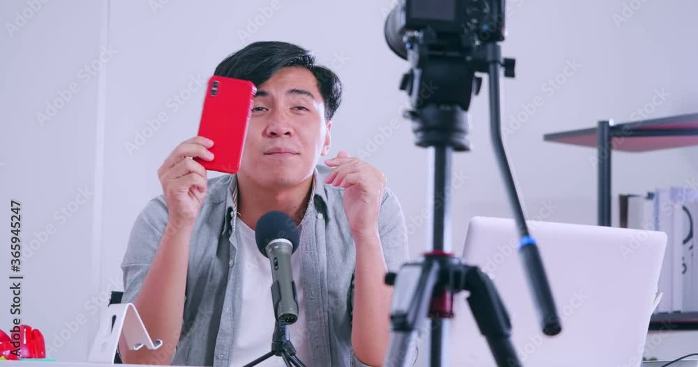 Young Asia man selling digital gadgets on social media by streaming live from his home. Young Asia man selling digital gadgets on social media by streaming live from his home.