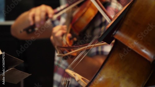 cellist playing cello in orchestra slow motion photo