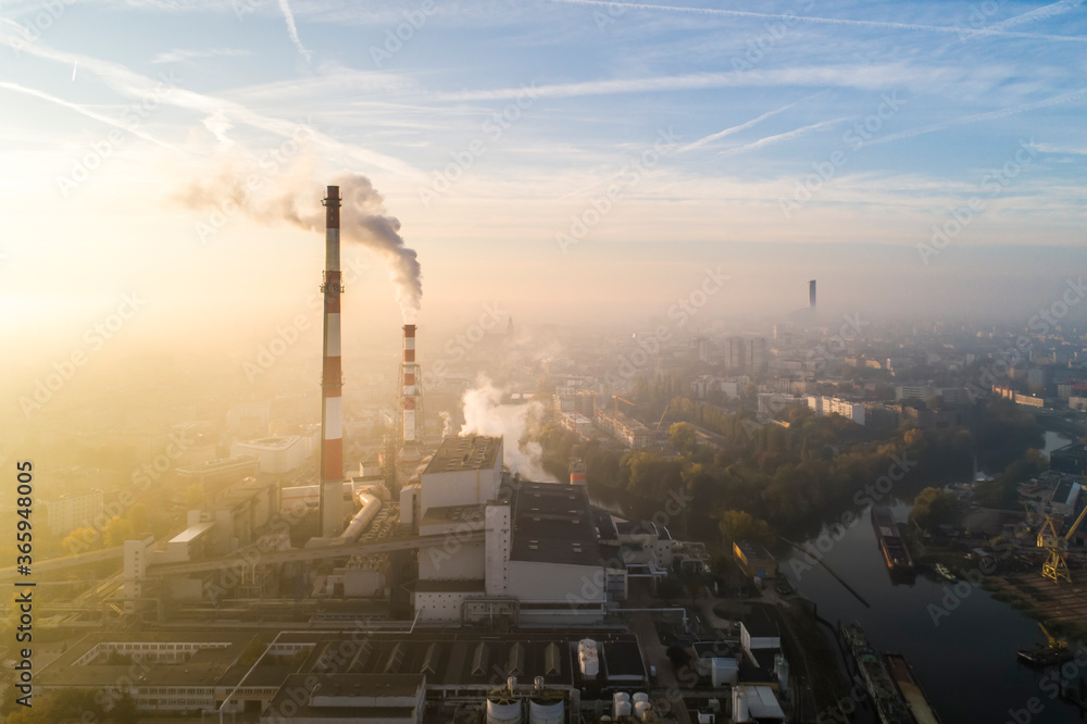 Aerial view of the smog over the city in the morning, smoking chimneys of the CHP plant and the city's buildings - Wroclaw, Poland