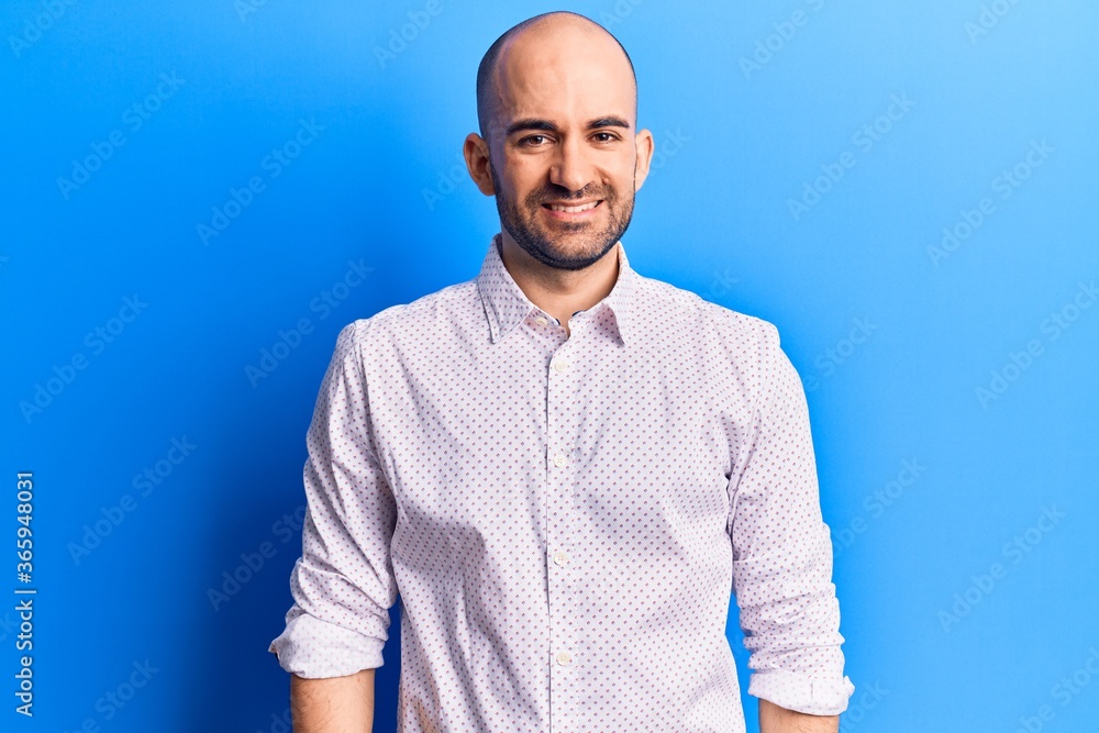 Young handsome bald man wearing elegant shirt with a happy and cool smile on face. lucky person. Young handsome bald man wearing elegant shirt with a happy and cool smile on face. lucky person.