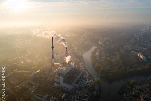 Aerial view of the smog over the city in the morning, smoking chimneys of the CHP plant and the city's buildings - Wroclaw, Poland