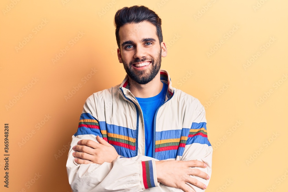 Young handsome man with beard wearing casual jacket happy face smiling with crossed arms looking at the camera. positive person. Young handsome man with beard wearing casual jacket happy face smiling with crossed arms looking at the camera. positive person.
