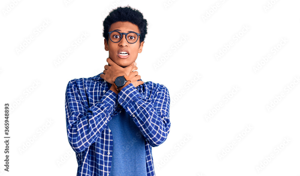 Young african american man wearing casual clothes and glasses shouting and suffocate because painful strangle. health problem. asphyxiate and suicide concept.
