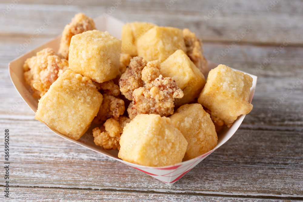 A view of a plate of deep fried tofu and popcorn chicken. A view of a plate of deep fried tofu and popcorn chicken.