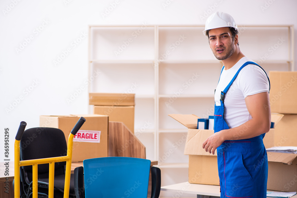 Young male professional mover doing home relocation Young male professional mover doing home relocation