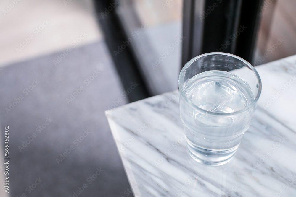 Glass of purified fresh drink water on marble table in cafe or coffee shop.Concept: nature, purification, freshness. Glass of purified fresh drink water on marble table in cafe or coffee shop.Concept: nature, purification, freshness.