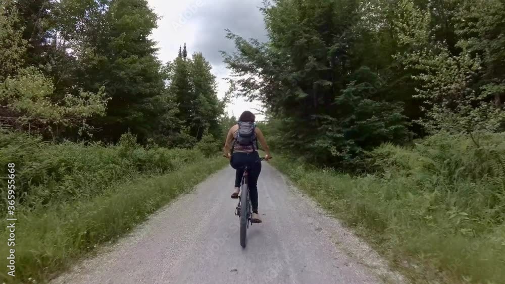 Rear view of woman riding a bike Rear view of woman riding a bike