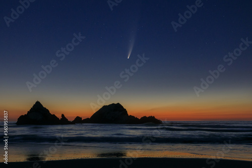 Comet Neowise at sunset over off-shore rock formations