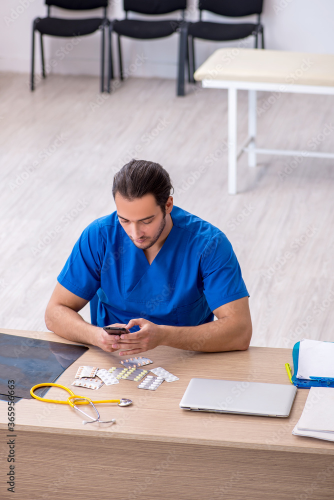 Young male doctor working in the clinic Young male doctor working in the clinic