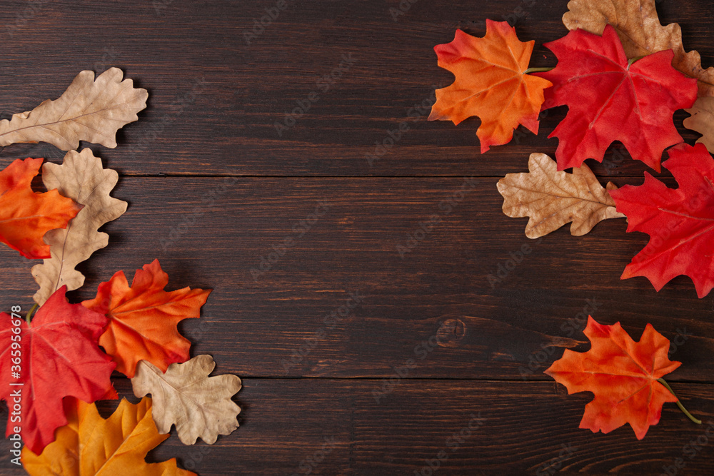 Autumn maple leaves on brown wooden table