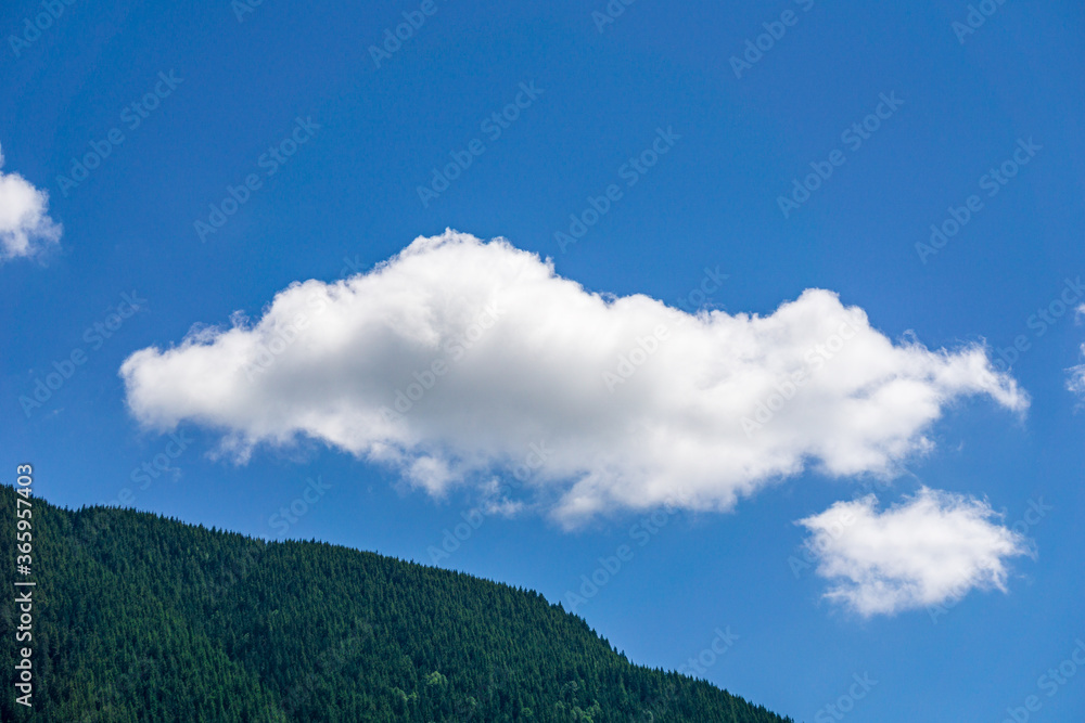 mountains covered with green forest blue sky with white clouds mountains covered with green forest blue sky with white clouds
