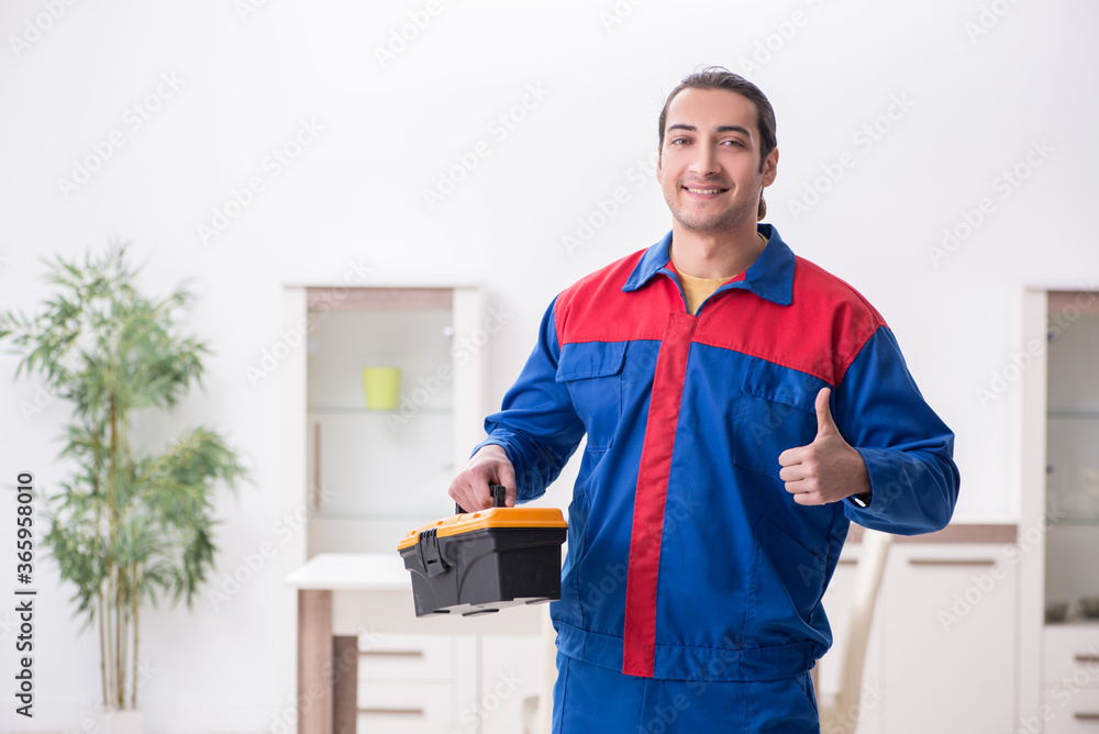 Young male carpenter working indoors Young male carpenter working indoors
