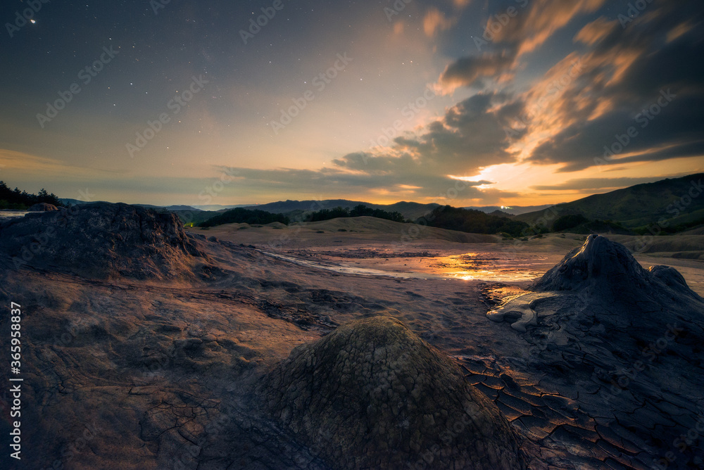 Moon set scene in the night with a starry sky at the muddy volcanoes in Romania Buzau County