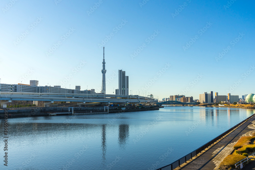 Tokyo Skytree with blue sky background and Sumida river as foreground in Tokyo, Japan 