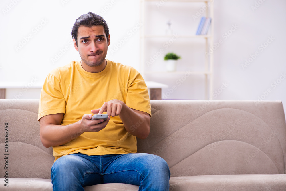 Young man watching tv at home Young man watching tv at home